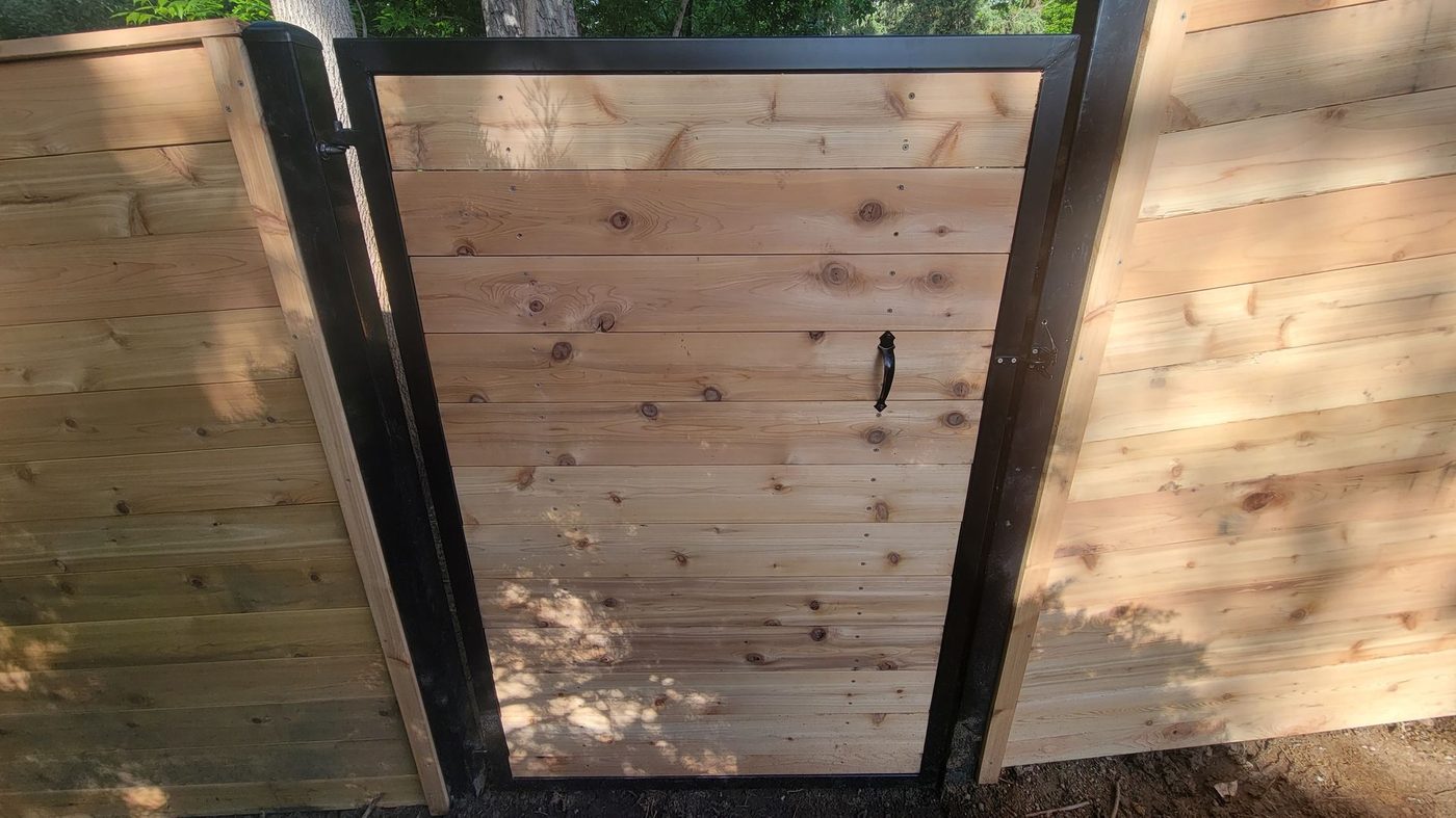 Modern horizontal cedar fence with black gate frame Louisville