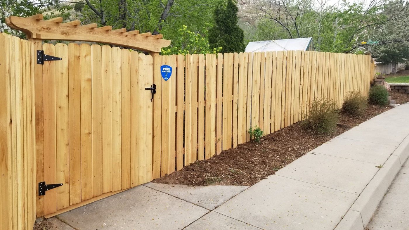 Cedar privacy fence with an arched pergola gate in Louisville KY